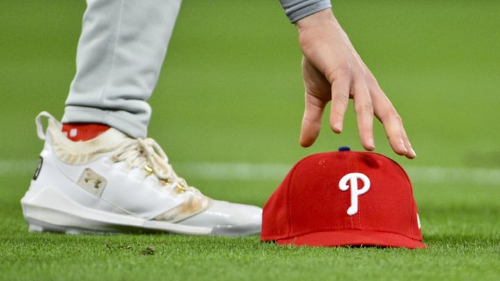 Apr 11, 2025; St. Louis, Missouri, USA;  Philadelphia Phillies third baseman Alec Bohm (28) picks up his hat after chasing down a fly ball against the St. Louis Cardinals during the third inning at Busch Stadium. Mandatory Credit: Jeff Curry-Imagn Images