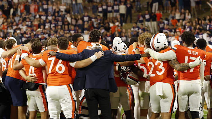 Oct 18, 2025; Charlottesville, Virginia, USA; Virginia Cavaliers players and staff sign the school song in font of the student sections after their game against the Washington State Cougars at Scott Stadium. Mandatory Credit: Geoff Burke-Imagn Images