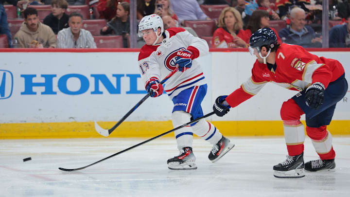 Dec 28, 2024; Sunrise, Florida, USA; Montreal Canadiens right wing Cole Caufield (13) shoots the puck past Florida Panthers defenseman Dmitry Kulikov (7) during the second period at Amerant Bank Arena. Mandatory Credit: Sam Navarro-Imagn Images Dec 28, 2024; Sunrise, Florida, USA; Montreal Canadiens right wing Cole Caufield (13) shoots the puck past Florida Panthers defenseman Dmitry Kulikov (7) during the second period at Amerant Bank Arena. Mandatory Credit: Sam Navarro-Imagn Images