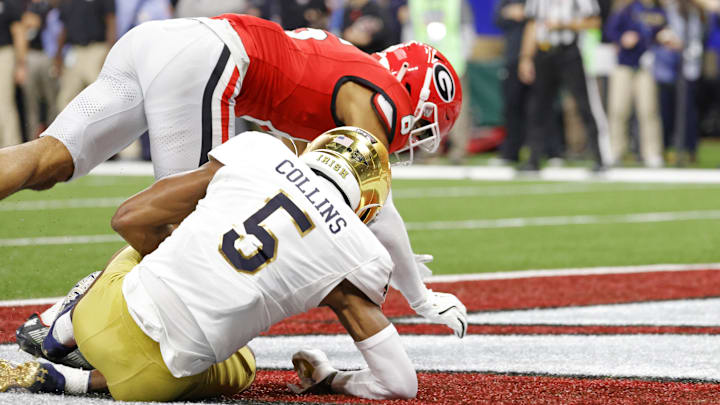 Jan 2, 2025; New Orleans, LA, USA; Notre Dame Fighting Irish wide receiver Beaux Collins (5) scores a touch down during the second quarter against Georgia Bulldogs defensive back Daylen Everette (6) during the first half at Caesars Superdome. 