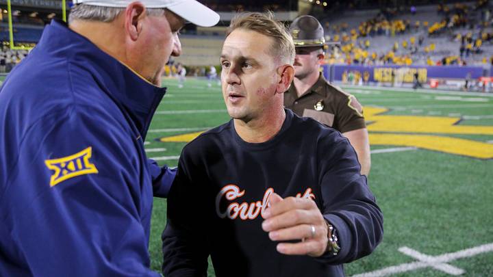 Sep 26, 2026; Morgantown, West Virginia, USA; Oklahoma State Cowboys head coach Eric Morris speaks to West Virginia Mountaineers head coach Rich Rodriguez after the game at Milan Puskar Stadium. Mandatory Credit: Ben Queen-Imagn Images Sep 26, 2026; Morgantown, West Virginia, USA; Oklahoma State Cowboys head coach Eric Morris speaks to West Virginia Mountaineers head coach Rich Rodriguez after the game at Milan Puskar Stadium. Mandatory Credit: Ben Queen-Imagn Images
