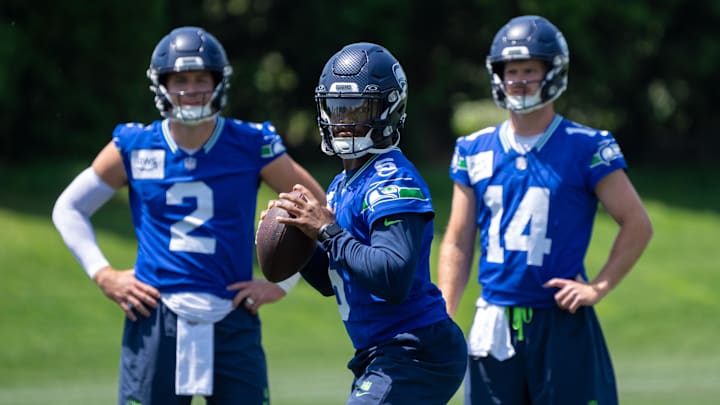 Jun 11, 2025; Renton, WA, USA; Seattle Seahawks quarterback Jalen Milroe (6) looks to pass as quarterback Drew Lock (2) and quarterback Sam Darnold (14) during mini-camp at Virginia Mason Athletic Center. 