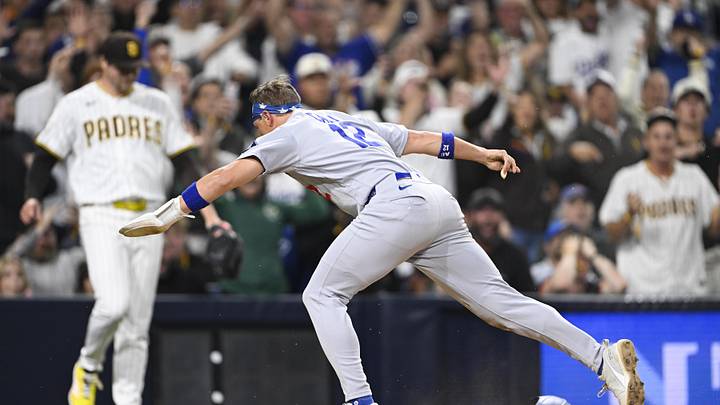 May 19, 2026; San Diego, California, USA; Los Angeles Dodgers left fielder Alex Call (12) scores as San Diego Padres pitcher Mason Miller (22) looks on during the ninth inning at Petco Park. Mandatory Credit: Denis Poroy-Imagn Images