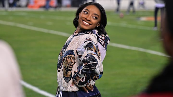 United States gymnast Simone Biles poses for a photo on the sidelines before the game between the Chicago Bears and the Seattle Seahawks at Soldier Field. United States gymnast Simone Biles poses for a photo on the sidelines before the game between the Chicago Bears and the Seattle Seahawks at Soldier Field.