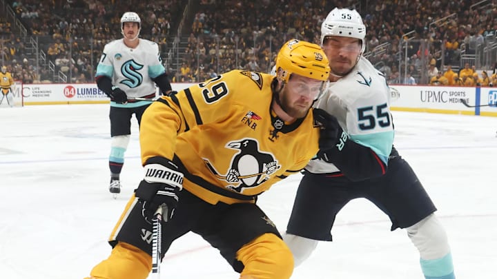 Nov 22, 2025; Pittsburgh, Pennsylvania, USA;  Pittsburgh Penguins right wing Anthony Mantha (39) skates with the puck against pressure from Seattle Kraken defenseman Ryan Lindgren (55) during the first period at PPG Paints Arena. Mandatory Credit: Charles LeClaire-Imagn Images