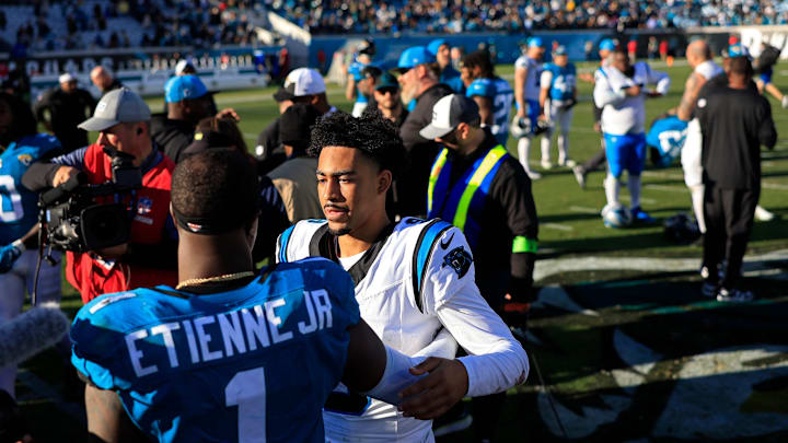 Jacksonville Jaguars running back Travis Etienne Jr. (1) talks with Carolina Panthers quarterback Bryce Young (9) after the game of a regular season NFL football matchup Sunday, Dec. 31, 2023 at EverBank Stadium in Jacksonville, Fla. The Jacksonville Jaguars blanked the Carolina Panthers 26-0.