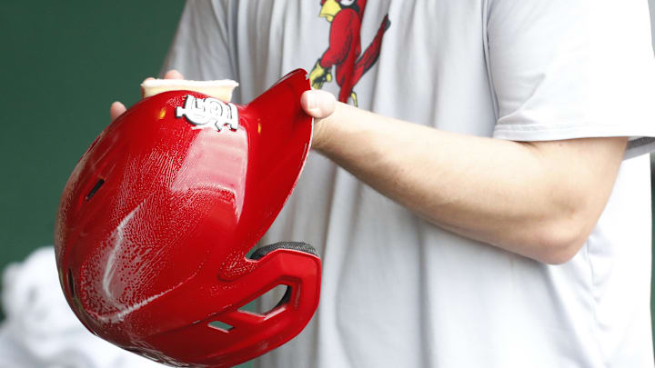 Jul 3, 2024; Pittsburgh, Pennsylvania, USA;  A St. Louis Cardinals equipment manager shines the batting helmets prior to a game against the Pittsburgh Pirates at PNC Park. Mandatory Credit: Charles LeClaire-Imagn Images