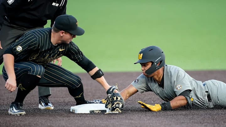 Missouri catcher Jedier Hernandez (24) slides in safely on a double next to Vanderbilt third baseman