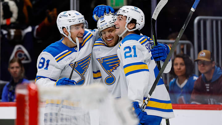 Apr 5, 2026; Denver, Colorado, USA; St. Louis Blues center Robert Thomas (18) celebrates his third goal of the game with left wing Dylan Holloway (81) and right wing Jimmy Snuggerud (21) in the third period against the Colorado Avalanche at Ball Arena. Mandatory Credit: Isaiah J. Downing-Imagn Images