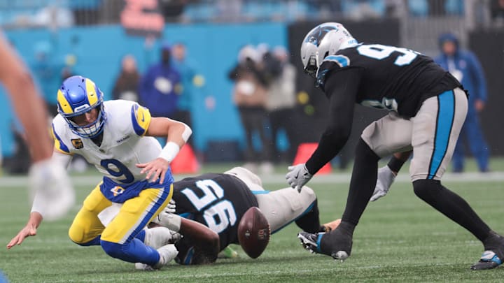 Nov 30, 2025; Charlotte, North Carolina, USA; Los Angeles Rams quarterback Matthew Stafford (9) is sacked by Carolina Panthers defensive end Derrick Brown (95) and fumbles the ball as Carolina Panthers linebacker D.J. Wonnum (98) recovers the football during the fourth quarter at Bank of America Stadium. Mandatory Credit: Scott Kinser-Imagn Images