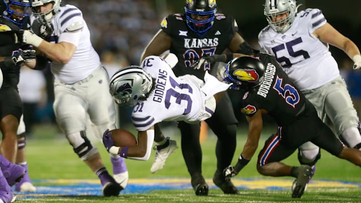 Kansas junior safetey O.J. Burroughs (5) takes down Kansas State sophomore running back DJ Giddens