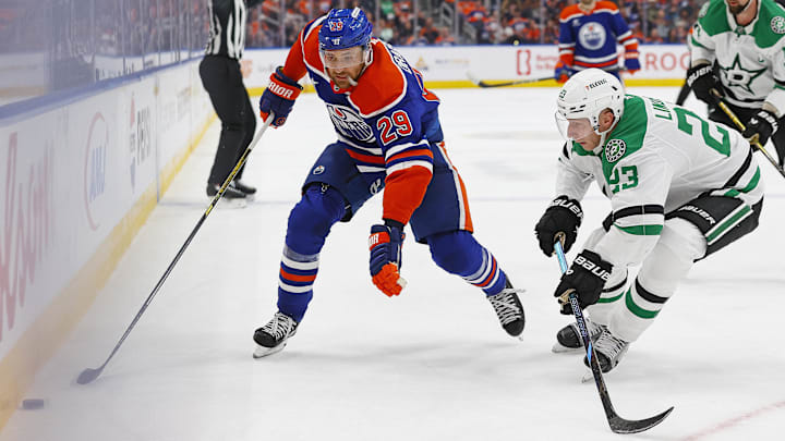 Mar 8, 2025; Edmonton, Alberta, CAN; Edmonton Oilers forward Leon Draisaitl (29) tries to carry the puck around Dallas Stars defensemen Esa Lindell (23) during the first period at Rogers Place. Mandatory Credit: Perry Nelson-Imagn Images