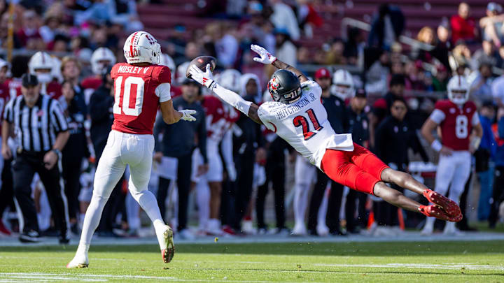 Nov 16, 2024; Stanford, California, USA;  Louisville Cardinals defensive back D'Angelo Hutchinson (21) attempts to deflect a pass to Stanford Cardinal wide receiver Emmett Mosley V (10) during the first quarter at Stanford Stadium. Mandatory Credit: Bob Kupbens-Imagn Images