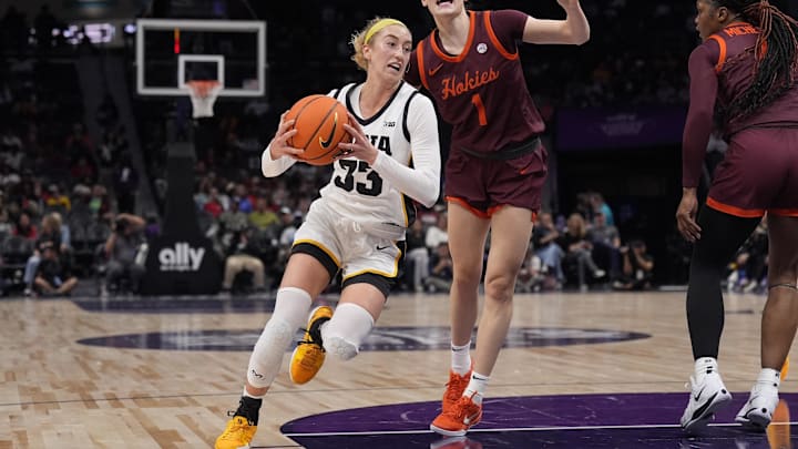 Nov 10, 2024; Charlotte, NC, USA; Iowa Hawkeyes guard Lucy Olsen (33) drives to the basket against Virginia Tech Hokies guard Carleigh Wenzel (1) during the first half at Spectrum Center. Mandatory Credit: Jim Dedmon-Imagn Images Nov 10, 2024; Charlotte, NC, USA; Iowa Hawkeyes guard Lucy Olsen (33) drives to the basket against Virginia Tech Hokies guard Carleigh Wenzel (1) during the first half at Spectrum Center. Mandatory Credit: Jim Dedmon-Imagn Images