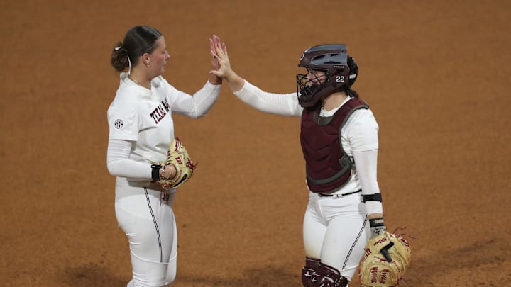 May 9, 2025; Athens, GA, USA; Texas A&M starting pitcher/relief pitcher Emiley Kennedy (11) and Texas A&M catcher Gracyn Coleman (22) high-five during a game against Texas at Jack Turner Stadium. Mandatory Credit: Mady Mertens-Imagn Images