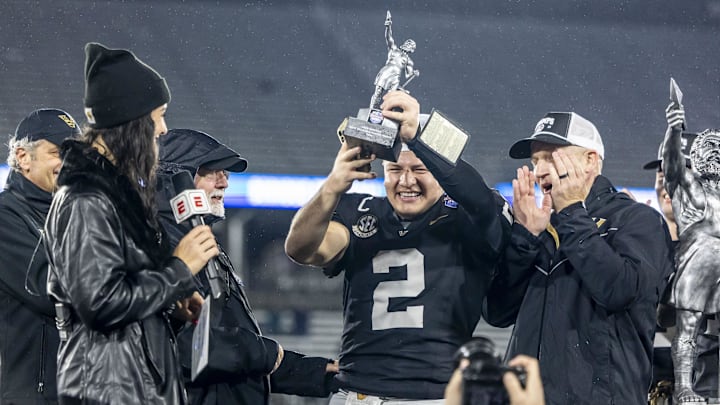 Dec 27, 2024; Birmingham, AL, USA;  Vanderbilt Commodores quarterback Diego Pavia (2) hoists the MVP trophy after defeating the Georgia Tech Yellow Jackets in the 2024 Birmingham Bowl at Protective Stadium. Mandatory Credit: Vasha Hunt-Imagn Images