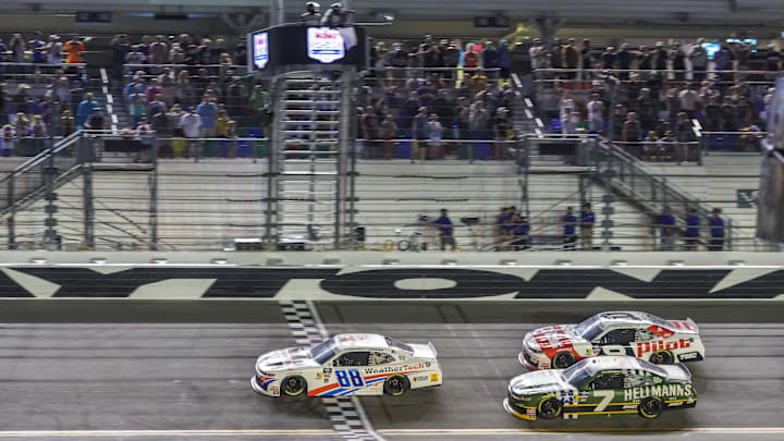 Aug 22, 2025; Daytona Beach, Florida, USA; NASCAR Xfinity Series driver Parker Kligerman (88) crosses the finish line on final lap to win in overtime under caution during the Wawa 250 at Daytona International Speedway.