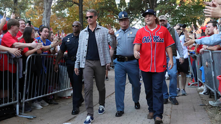 Nov 15, 2025; Oxford, Mississippi, USA; Mississippi Rebels head coach Lane Kiffin and comedian Theo Von make their way down the Walk of Champion to Vaught-Hemingway Stadium prior to the game against the Florida Gators. Mandatory Credit: Petre Thomas-Imagn Images