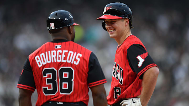 Chicago White Sox catcher Kyle Teel (8) smiles after his first major league hit alongside first base coach Jason Bourgeois (38) against the Kansas City Royals at Rate Field. 