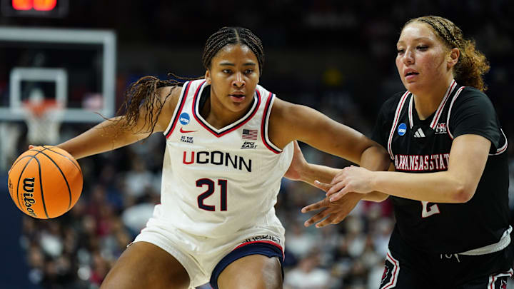Mar 22, 2025; Storrs, Connecticut, USA; UConn Huskies forward Sarah Strong (21) drives the ball against Arkansas State Red Wolves guard Wynter Rogers (2) in the first half at Harry A. Gampel Pavilion. Mandatory Credit: David Butler II-Imagn Images