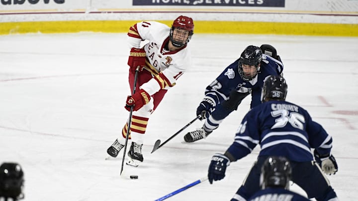 Feb 28, 2025; Chestnut Hill, MA, USA; Boston College defenseman Michael Hagens (11) avoids the check from New Hampshire forward Liam Devlin (12) during the first period at Conte Forum. Mandatory Credit: Eric Canha-Imagn Images