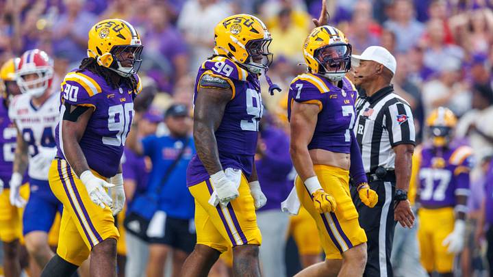 Sep 12, 2026; Baton Rouge, Louisiana, USA; LSU Tigers defensive tackle Deuce Geralds (99) and linebacker Whit Weeks (7) react to sacking Louisiana Tech Bulldogs quarterback Blake Baker (5) during the first half at Tiger Stadium. Mandatory Credit: Stephen Lew-Imagn Images Sep 12, 2026; Baton Rouge, Louisiana, USA; LSU Tigers defensive tackle Deuce Geralds (99) and linebacker Whit Weeks (7) react to sacking Louisiana Tech Bulldogs quarterback Blake Baker (5) during the first half at Tiger Stadium. Mandatory Credit: Stephen Lew-Imagn Images