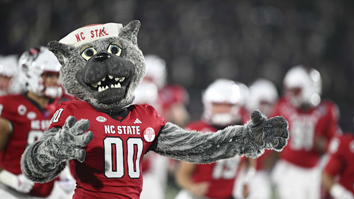 Dec 28, 2024; Annapolis, MD, USA; North Carolina State Wolfpack mascot Mr. Wolf runs ion the field with the team before the start of the Go Bowling Military Bowl against the East Carolina Pirates at Navy-Marine Corps Memorial Stadium. Mandatory Credit: Tommy Gilligan-Imagn Images Dec 28, 2024; Annapolis, MD, USA; North Carolina State Wolfpack mascot Mr. Wolf runs ion the field with the team before the start of the Go Bowling Military Bowl against the East Carolina Pirates at Navy-Marine Corps Memorial Stadium. Mandatory Credit: Tommy Gilligan-Imagn Images