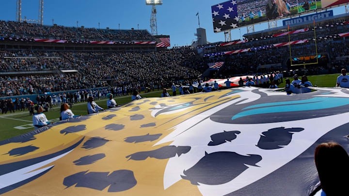 Season Ticket Holders hold the giant Jaguars logo at center field during the singing of the National Anthem. The Jacksonville Jaguars hosted the Carolina Panthers at EverBank Stadium in Jacksonville, FL Sunday, December 31, 2023. The Jaguars went in at the half with a 9 to 0 lead. [Bob Self/Florida Times-Union]