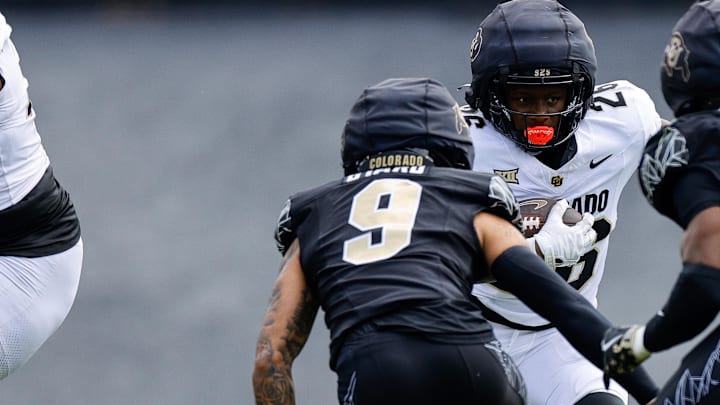 Apr 19, 2025; Boulder, CO, USA; Colorado Buffaloes running back Brandon Hood (26) runs the ball against safety Tawfiq Byard (9) and linebacker Reginald Hughes (50) during the spring game at Folsom Field. Mandatory Credit: Isaiah J. Downing-Imagn Images
