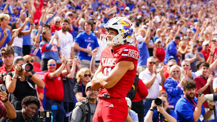 Sep 28, 2024; Kansas City, Missouri, USA; Kansas Jayhawks wide receiver Luke Grimm (11) celebrates after scoring against the TCU Horned Frogs during the first half at GEHA Field at Arrowhead Stadium. Mandatory Credit: Denny Medley-Imagn Images