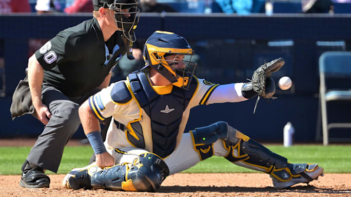 Feb 21, 2026; Phoenix, Arizona, USA;  Umpire Brian Walsh (60) makes the call behind Milwaukee Brewers catcher Reese McGuire (33) against the Cleveland Guardians at American Family Fields of Phoenix. Mandatory Credit: Jayne Kamin-Oncea-Imagn Images