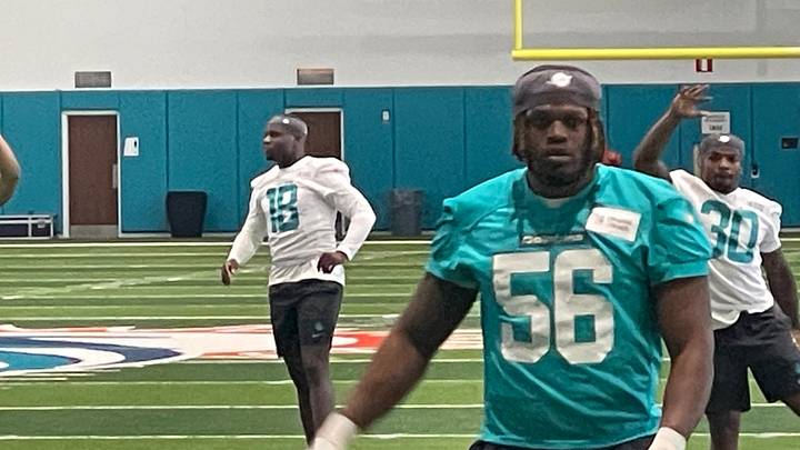 Miami Dolphins players stretch on the first day of the 2026 rookie minicamp