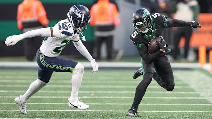 Dec 1, 2024; East Rutherford, New Jersey, USA; New York Jets wide receiver Garrett Wilson (5) fights for yards as Seattle Seahawks cornerback Josh Jobe (29) defends during the second half at MetLife Stadium.