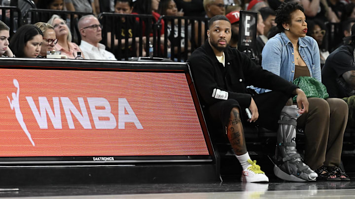 May 30, 2025; Las Vegas, Nevada, USA; NBA player Damian Lillard sits courtside during the Las Vegas Aces and Los Angeles Sparks game at Michelob Ultra Arena. Mandatory Credit: Candice Ward-Imagn Images May 30, 2025; Las Vegas, Nevada, USA; NBA player Damian Lillard sits courtside during the Las Vegas Aces and Los Angeles Sparks game at Michelob Ultra Arena. Mandatory Credit: Candice Ward-Imagn Images