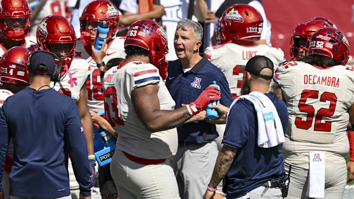 Oct 18, 2025; Houston, Texas, USA; Arizona Wildcats head coach Brent Brennan reacts in the huddle during the third quarter against the Houston Cougars at TDECU Stadium. Mandatory Credit: Maria Lysaker-Imagn Images