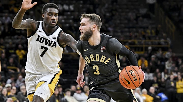Purdue Boilermakers guard Braden Smith (3) is defended by Iowa Hawkeyes forward Seydou Traore (7) 