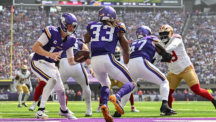 Sep 15, 2024; Minneapolis, Minnesota, USA; Minnesota Vikings quarterback Sam Darnold (14) and running back Aaron Jones (33) in action against the San Francisco 49ers during the game at U.S. Bank Stadium. Mandatory Credit: Jeffrey Becker-Imagn Images