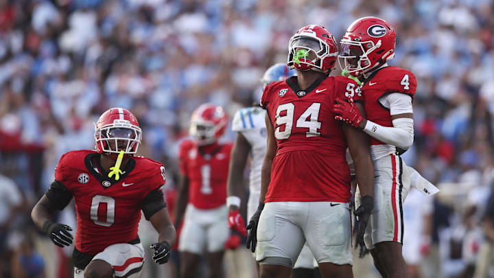 Oct 18, 2025; Athens, Georgia, USA;  Georgia Bulldogs defensive tackle Xzavier McLeod (94) reacts with defensive back Kj Bolden (4) after breaking up a pass against the Mississippi Rebels during the second half of the game at Sanford Stadium. Mandatory Credit: Brett Davis-Imagn Images