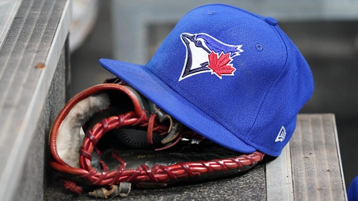 Apr 16, 2025; Toronto, Ontario, CAN; A Toronto Blue Jays hat and glove in the dugout during a game against the Atlanta Braves at Rogers Centre. 