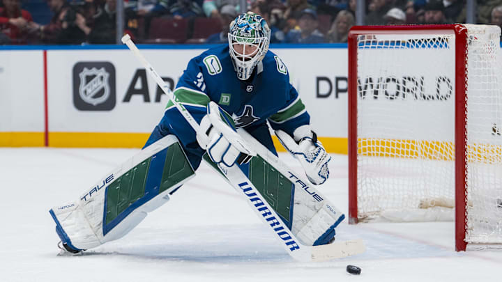 Mar 15, 2025; Vancouver, British Columbia, CAN; Vancouver Canucks goalie Arturs Silovs (31) handles the puck against the Chicago Blackhawks in the second period at Rogers Arena. Mandatory Credit: Bob Frid-Imagn Images