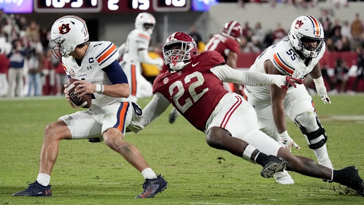 Nov 30, 2024; Tuscaloosa, Alabama, USA; Alabama Crimson Tide defensive lineman LT Overton (22) pressures Auburn Tigers quarterback Payton Thorne (1) during the second half at Bryant-Denny Stadium. Alabama won 28-14. Mandatory Credit: Gary Cosby Jr.-Imagn Images Nov 30, 2024; Tuscaloosa, Alabama, USA; Alabama Crimson Tide defensive lineman LT Overton (22) pressures Auburn Tigers quarterback Payton Thorne (1) during the second half at Bryant-Denny Stadium. Alabama won 28-14. Mandatory Credit: Gary Cosby Jr.-Imagn Images