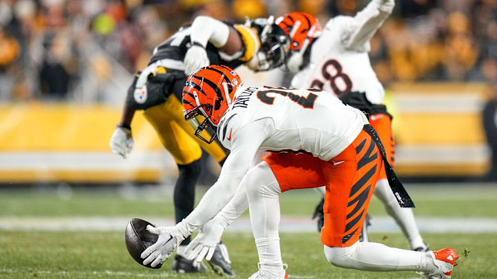 Cincinnati Bengals cornerback Cam Taylor-Britt (29) chases a tipped pass to Pittsburgh Steelers wide receiver George Pickens (14) in the fourth quarter of the NFL Week 18 game between the Pittsburgh Steelers and the Cincinnati Bengals at Acrisure Stadium in Pittsburgh on Saturday, Jan. 4, 2025. The Bengals won 19-17 to finish the regular season at 9-8. Cincinnati Bengals cornerback Cam Taylor-Britt (29) chases a tipped pass to Pittsburgh Steelers wide receiver George Pickens (14) in the fourth quarter of the NFL Week 18 game between the Pittsburgh Steelers and the Cincinnati Bengals at Acrisure Stadium in Pittsburgh on Saturday, Jan. 4, 2025. The Bengals won 19-17 to finish the regular season at 9-8.