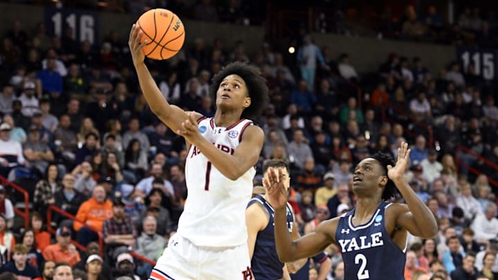 Mar 22, 2024; Spokane, WA, USA; Auburn Tigers guard Aden Holloway (1) attempts a layup against Yale Bulldogs guard Bez Mbeng (2) during the second half of a game in the first round of the 2024 NCAA Tournament at Spokane Veterans Memorial Arena. Mandatory Credit: James Snook-Imagn Images 