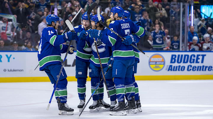 Dec 16, 2024; Vancouver, British Columbia, CAN; Vancouver Canucks forward Pius Suter (24) and forward Danton Heinen (20) and forward Kiefer Sherwood (44) and defenseman Noah Juulsen (47) and defenseman Carson Soucy (7) celebrate SHerwood’s goal against the Colorado Avalanche during the first period at Rogers Arena. Mandatory Credit: Bob Frid-Imagn Images