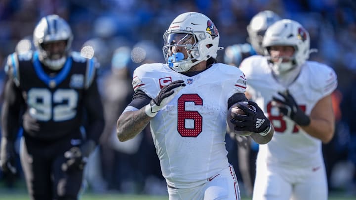 Dec 22, 2024; Charlotte, North Carolina, USA; Arizona Cardinals running back James Conner (6) runs for yardage against the Carolina Panthers during the second quarter at Bank of America Stadium. Mandatory Credit: Jim Dedmon-Imagn Images