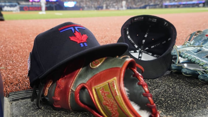 Jul 19, 2024; Toronto, Ontario, CAN; A Toronto Blue Jays hat and glove near the dugout during a game against the Detroit Tigers at Rogers Centre. Mandatory Credit: John E. Sokolowski-Imagn Images Jul 19, 2024; Toronto, Ontario, CAN; A Toronto Blue Jays hat and glove near the dugout during a game against the Detroit Tigers at Rogers Centre. Mandatory Credit: John E. Sokolowski-Imagn Images