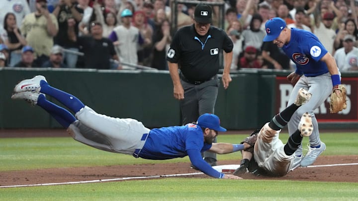 Mar 29, 2025; Phoenix, Arizona, USA; Chicago Cubs shortstop Dansby Swanson (7) tags out Arizona Diamondbacks outfielder Garrett Hampson (8) at thirdbase to end the game in the ninth inning at Chase Field. Mandatory Credit: Rick Scuteri-Imagn Images