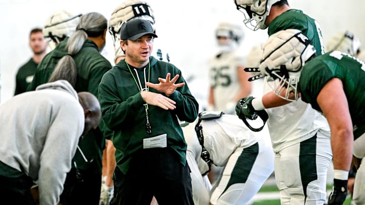 Michigan State's head coach Jonathan Smith, left, talks with Justin Bell during football practice on Tuesday, April 8, 2025, in East Lansing.