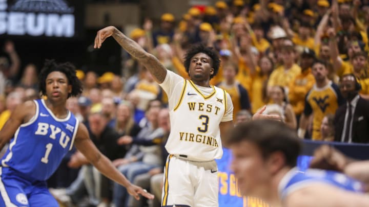 Feb 28, 2026; Morgantown, West Virginia, USA; West Virginia Mountaineers guard Honor Huff (3) shoots a three point shot over BYU Cougars guard Robert Wright III (1) during the second half at Hope Coliseum. 