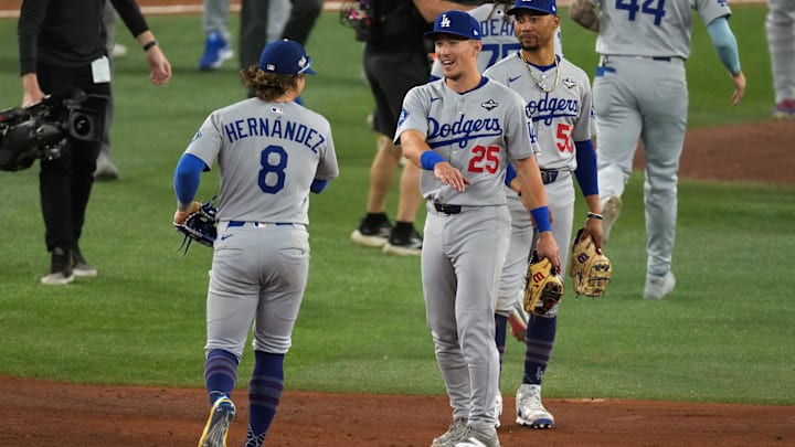 Oct 25, 2025; Toronto, Ontario, CAN; Los Angeles Dodgers second baseman Tommy Edman (25) and first baseman Enrique Hernandez (8) celebrate after the win against the Toronto Blue Jays in game two of the 2025 MLB World Series at Rogers Centre. Mandatory Credit: Nick Turchiaro-Imagn Images